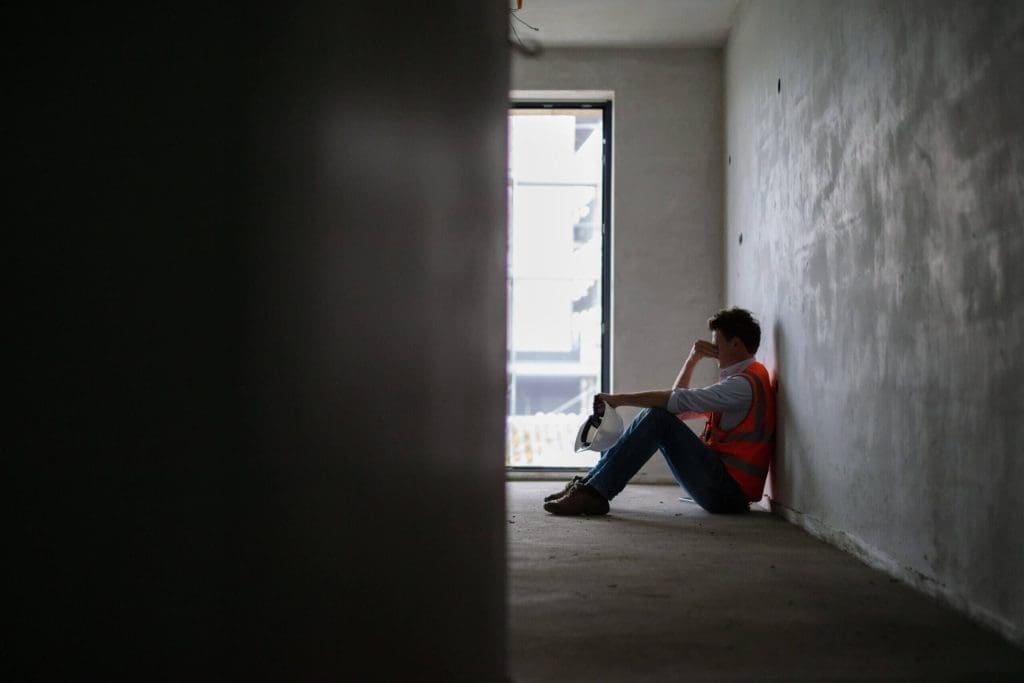 anti-slavery day 2024 showing man sat on floor in potential distress